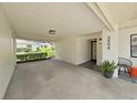 Covered carport showcasing lighting, house number, and decorative landscaping near the front door at 3504 Wedge Way, New Port Richey, FL 34655