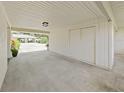 Attached carport with storage space, and view of driveway and neighboring house at 3504 Wedge Way, New Port Richey, FL 34655