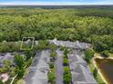 This aerial view showcases the townhouse and the surrounding lush trees at 3521 Kings Road #105 at 3521 Kings Rd # 105, Palm Harbor, FL 34685