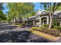 Charming townhouse exterior featuring well-maintained landscaping, neutral paint, and attached garages at 3521 Kings Rd # 105, Palm Harbor, FL 34685