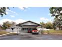 A single story home featuring a carport with room for a golf cart and a truck at 38819 Otis Allen Rd, Zephyrhills, FL 33540