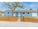 Charming blue single-Gathering home with a well-maintained front yard and a walkway leading to the front door at 410 Virginia Ave, Madeira Beach, FL 33708