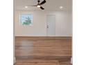 Living room features beautiful laminate flooring, recessed lighting, a modern fan, and plenty of natural light at 410 Virginia Ave, Madeira Beach, FL 33708