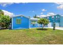 Charming turquoise home with a well-manicured lawn and lovely curb appeal, perfect for coastal living at 4492 Kingston Dr, Hernando Beach, FL 34607