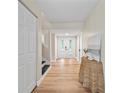 Bright entryway features wood floors, white trim, and a view to a bright living space at 4509 Grainary Ave, Tampa, FL 33624