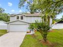 Charming two-story home with a well-manicured lawn and attached garage at 4509 Grainary Ave, Tampa, FL 33624