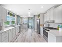 Bright, modern kitchen with stainless steel appliances, white cabinets, and a breakfast area with natural light at 4916 Palmetto Point Dr, Palmetto, FL 34221