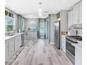 Bright, modern kitchen with stainless steel appliances, white cabinets, and a breakfast area with natural light at 4916 Palmetto Point Dr, Palmetto, FL 34221
