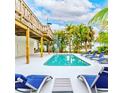 Beautiful pool with poolside seating surrounded by tropical landscaping, perfect for relaxation and outdoor entertaining at 4916 Palmetto Point Dr, Palmetto, FL 34221