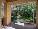 Enjoy the outdoors from this screened patio overlooking a lush green backyard with mature trees at 5125 Palm Springs Blvd # 3108, Tampa, FL 33647