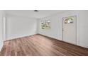Bright living room featuring wood flooring, fresh white paint and a large window for great natural light at 549 39Th Ne Ave, St Petersburg, FL 33703