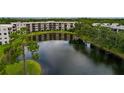 Scenic pond view with trees and condo building in the background at 6190 80Th N St # 310, St Petersburg, FL 33709