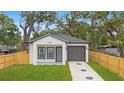 Nice view of this one-story home with a small from yard and one car garage at 7509 E 26Th Ave, Tampa, FL 33619
