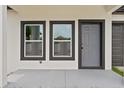 Close up of the front of the house showing the front door and a large window at 7509 E 26Th Ave, Tampa, FL 33619