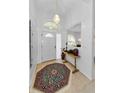 Bright foyer with tile flooring, decorative rug, and ample natural light, offering a warm welcome at 1051 Glynwood Pl, Dunedin, FL 34698