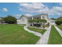 Charming home featuring a well-manicured lawn, walkway, and detached garage at 106 W Minnehaha St, Tampa, FL 33604