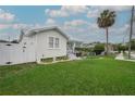 Well-maintained home with a lush green lawn, vibrant landscaping, and a classic white picket fence at 106 W Minnehaha St, Tampa, FL 33604