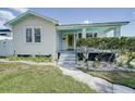 Charming home with a welcoming yellow door and meticulously landscaped front yard at 106 W Minnehaha St, Tampa, FL 33604