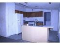 Kitchen area featuring cabinetry, a refrigerator, and a center island at 10641 Atlee St, New Port Richey, FL 34654