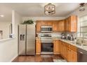 Updated kitchen features stainless appliances, granite countertops, and dark wood flooring at 10804 Bounty St, New Port Richey, FL 34654