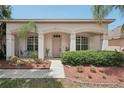 Inviting front porch with decorative landscaping and a seating area offers curb appeal and charm at 10905 Wildcat Dr, Riverview, FL 33579