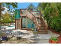 Charming two-story home with a pool, deck, and lush tropical landscaping for outdoor living at 111 29Th W St, Bradenton, FL 34205