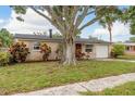 Charming single-story home featuring an attached garage and mature landscaping at 11320 125Th Ter, Largo, FL 33778