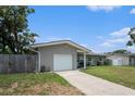 View of front of home with driveway and garage door at 1312 S Evergreen Ave, Clearwater, FL 33756