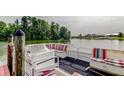 An inviting pontoon boat is docked at the lakefront property with red and white striped benches at 1407 Brattleboro Cir, Sun City Center, FL 33573