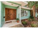 Inviting front entrance featuring a double door, decorative metalwork, and a cozy welcome mat at 152 58Th S Ave, St Petersburg, FL 33705