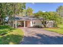 Charming home featuring a covered carport with stone pillars, offering both style and functionality in a serene setting at 15612 Howell Park Ln, Tampa, FL 33625