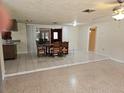 Open dining room with tile floors, adjacent to the kitchen, and featuring a view to an additional living area at 17306 Livingston Ave, Lutz, FL 33559