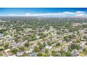 Overhead perspective of a dense, green residential area with a body of water and airport runway at 1737 Prince Philip St, Clearwater, FL 33755