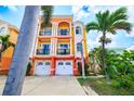 Beautiful three-story townhomes with white garages, balconies, pillars and tropical landscaping at 17817 Gulf Blvd # A, St Petersburg, FL 33708