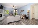 Spacious living room with hardwood floors, a fan, light blue walls, and comfortable seating at 1854 Lake Cypress Dr # 1854, Safety Harbor, FL 34695