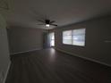 The living room has modern floors, a ceiling fan, and lots of natural light at 2045 Summit Dr, Dunedin, FL 34698