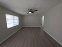Airy living room with ceiling fan, modern floors, and a large window at 2045 Summit Dr, Dunedin, FL 34698