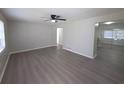 Bright living room featuring light gray walls, modern floors, and a ceiling fan at 2045 Summit Dr, Dunedin, FL 34698