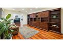 Cozy den with custom built-in wooden shelving and cabinets, offering ample storage and display space at 25238 Bunting Cir, Land O Lakes, FL 34639
