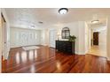 Spacious foyer featuring hardwood floors, elegant doors and trim, and tasteful decor, creating a welcoming entry at 25238 Bunting Cir, Land O Lakes, FL 34639