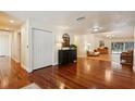 Bright and airy living area boasts hardwood flooring, with stylish furnishings and ample natural light at 25238 Bunting Cir, Land O Lakes, FL 34639