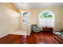 Inviting foyer with light-colored walls, decorative lighting, tile flooring, and wood accents leading to the living spaces at 28390 Openfield Loop, Wesley Chapel, FL 33543
