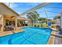 Inviting screened-in pool with a waterfall feature and spacious patio, ideal for relaxation at 2847 Mossy Timber Trl, Valrico, FL 33596