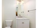 Cozy downstairs half-bath with a toilet, sink with chrome faucet, and a bright vanity light at 2876 Bayshore Trails Dr, Tampa, FL 33611