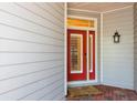 A bright red front door with white trim and shuttered windows, offering a welcoming entrance at 2876 Bayshore Trails Dr, Tampa, FL 33611