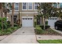 Inviting townhome with manicured landscaping, a one-car garage and neutral paint tones at 3053 Pointeview Dr, Tampa, FL 33611