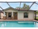 Rear exterior showing a screened pool with attached seating area at 3509 King George Ln, Seffner, FL 33584