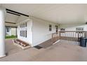 Covered carport with access ramp, mature landscape, and vinyl siding for easy maintenance at 36701 Jodi Ave, Zephyrhills, FL 33542