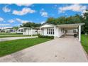 Attractive single-story home offering a covered carport, well-kept lawn, and a friendly neighborhood setting at 36701 Jodi Ave, Zephyrhills, FL 33542