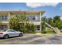 Charming exterior of a multi-unit home featuring a well-maintained lawn and convenient parking at 4154 56Th N St # 720, Kenneth City, FL 33709